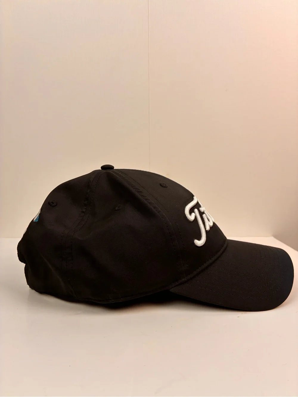 Titleist Tour Performance hat featuring embroidered Spectrum on the back OS